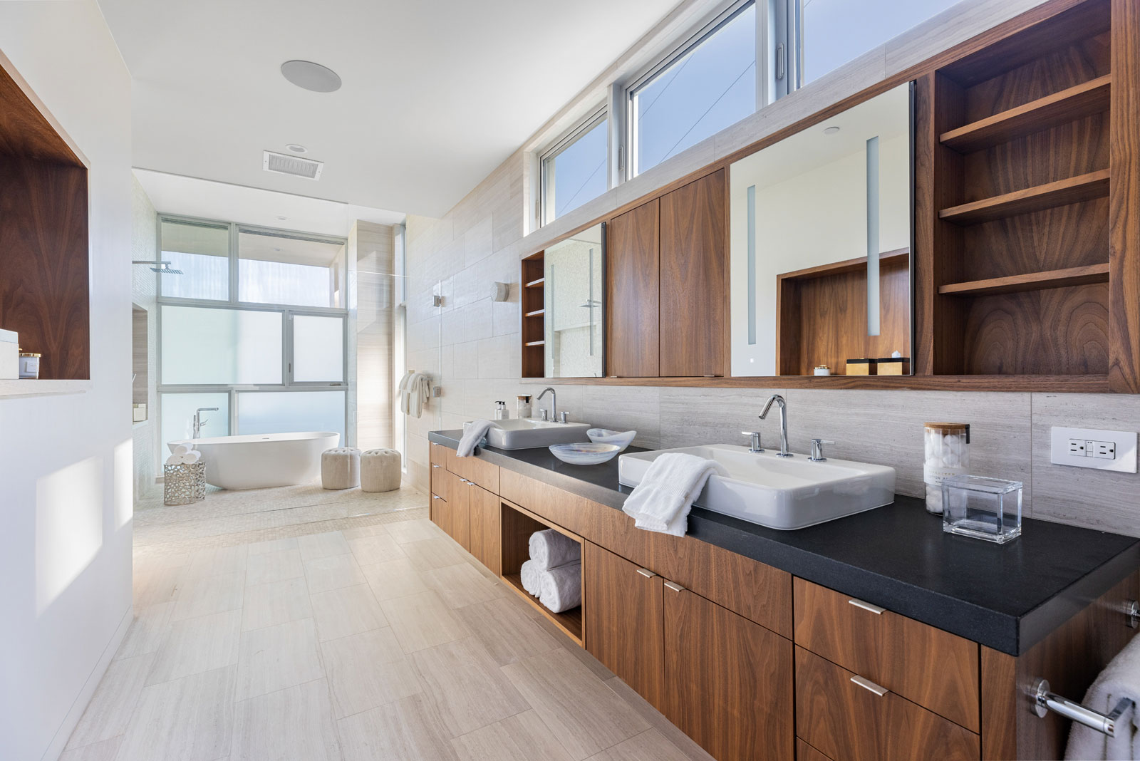 Walnut casework and Haisa light marble in the master bath. Photo: Photo: © Anthony Barcelo, Barcelo Photography
