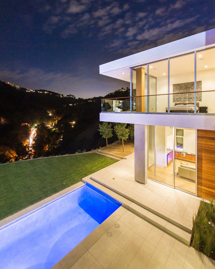 Looking past the pool, family room and master suite toward Laurel Canyon Boulevard below at night.