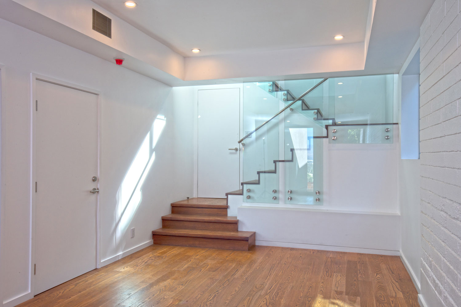 A view of the stair bathed in light.