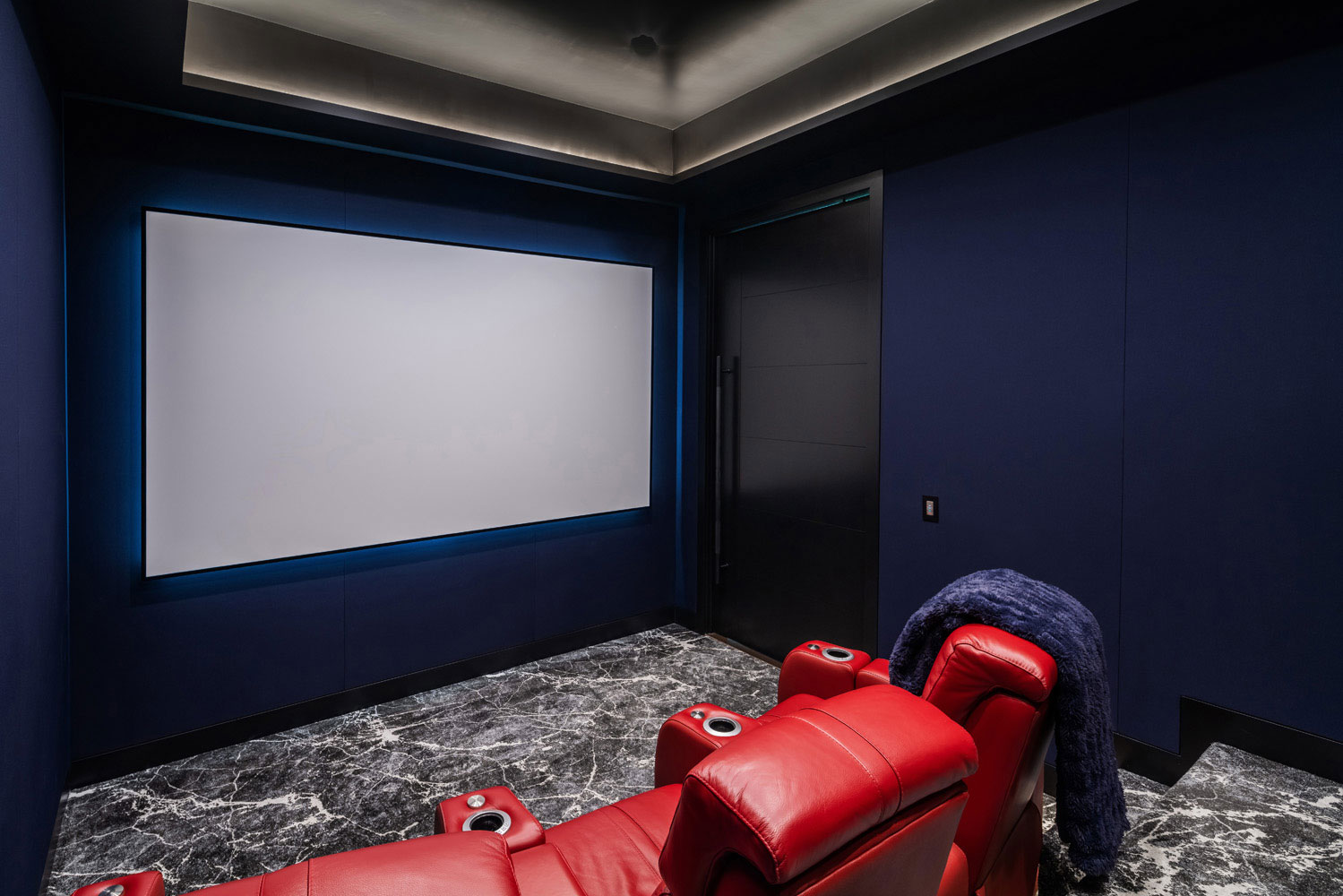 The media room features LED lighting, acoustical materials and concealed speakers.