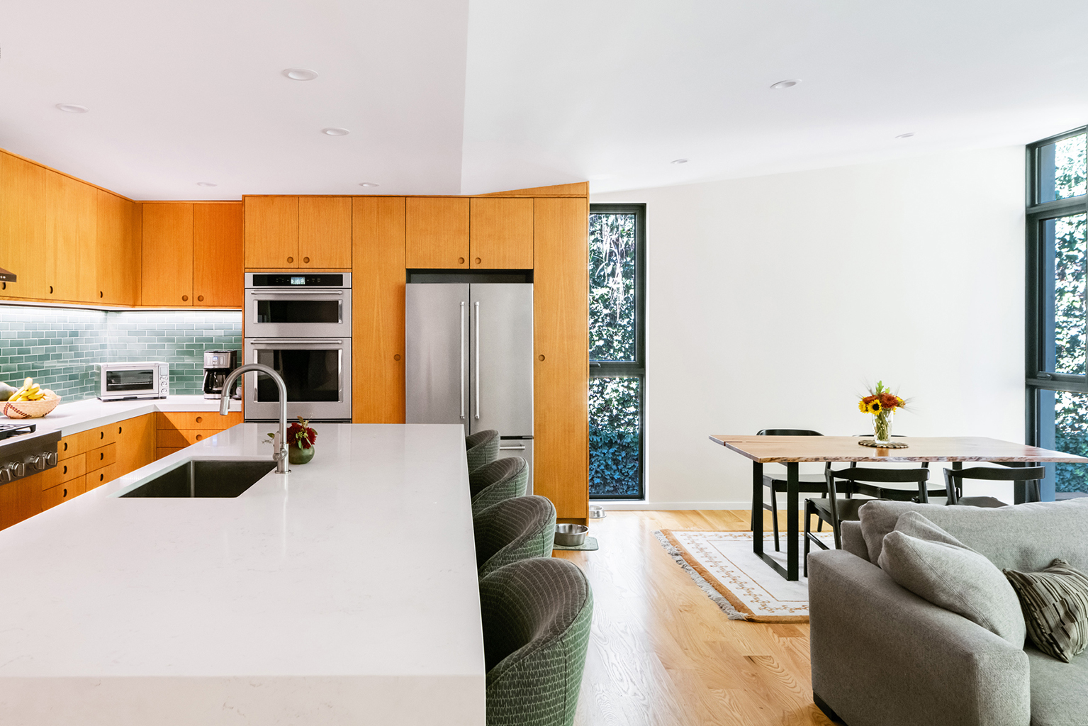 Looking down the island toward the side yard garden. The kitchen backsplash is from Heath Ceramics and the cabinets are by Reform. Photo: ©Paul Vu, Here and Now Agency